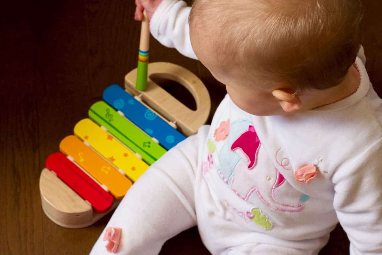Baby Playing With Wooden Music Instrument